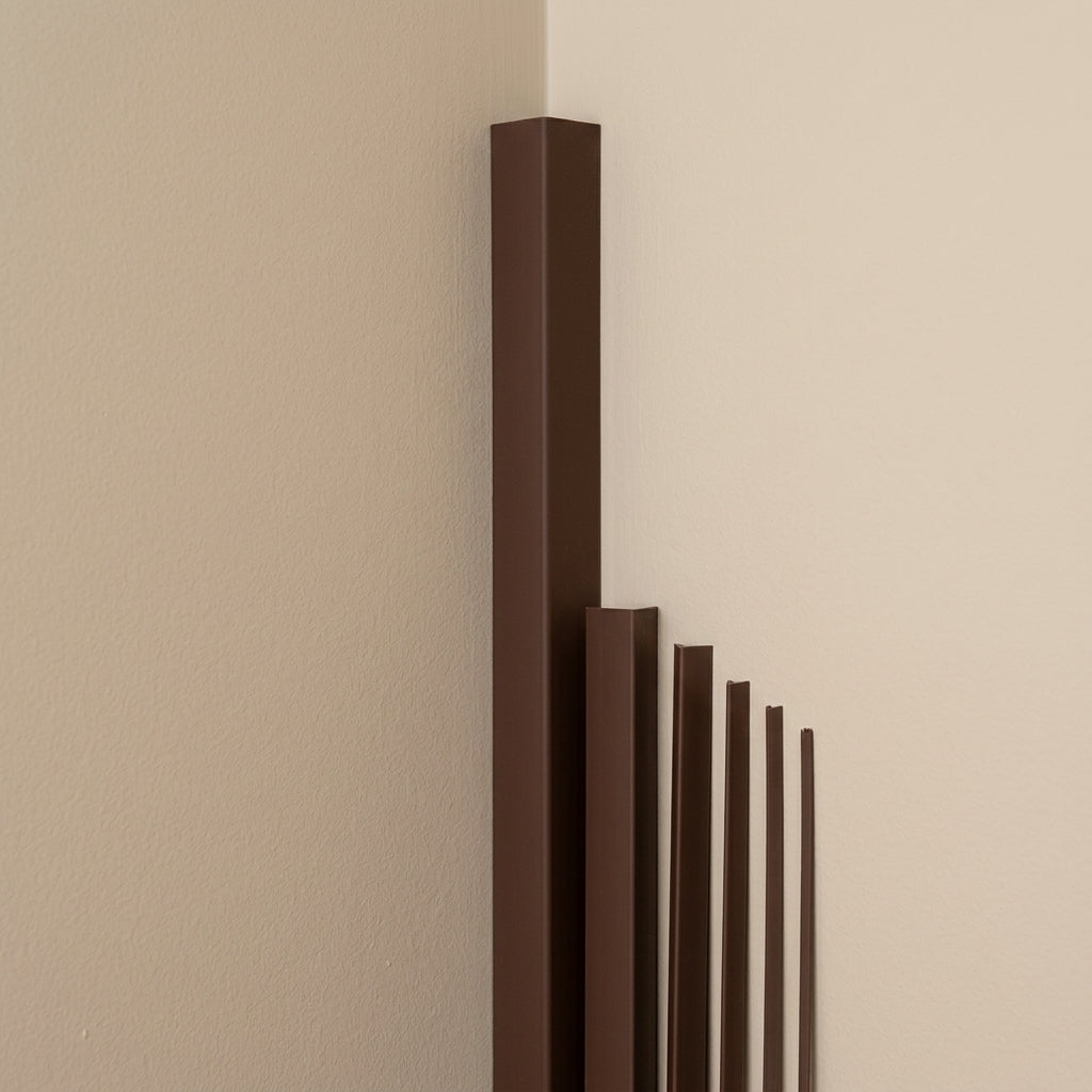 Brown PVC corner angle trim – different sizes on a wall