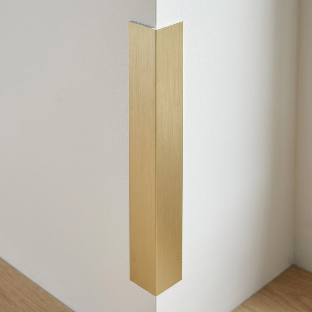 Brushed light gold aluminium angle trim – fitted on a wall corner