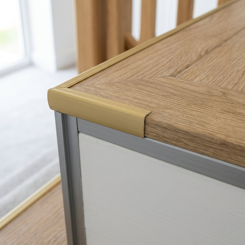 Aluminium LVT stair nosing outer corner for 5 mm LVT – close-up of a gold nosing on a stair edge